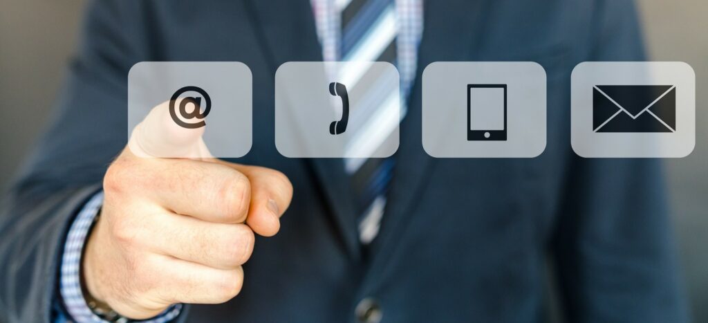 A photograph of a man selecting a button on a touchscreen.
